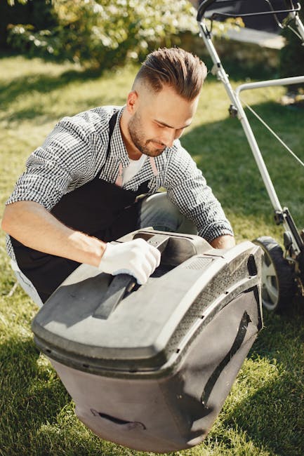 A close-up view of a metal toolbox filled with gardening tools and accessories, placed outdoors. Inside the box, there are rubber gloves with green and black checkered patterns, a pair of small sharp